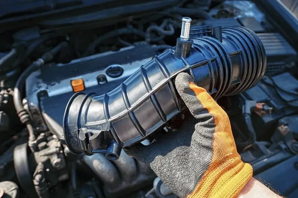 highlighted air intake hose in a clean engine bay